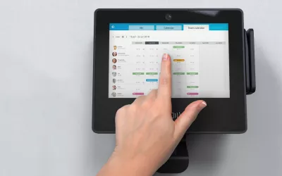Employee using a time tracking terminal to manage team calendar and schedules