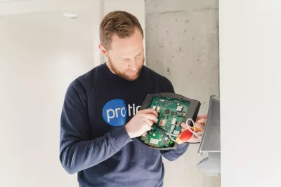 Technician performing maintenance on a time tracking terminal
