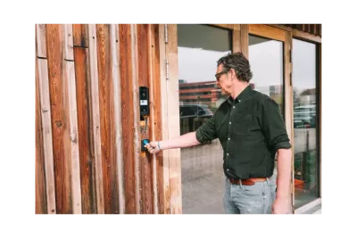 Employee using a badge to access a building through an access control terminal